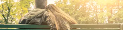 Young couple sitting on a park bench