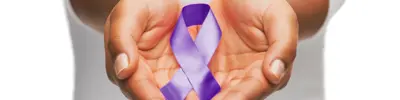 Close-up of two open hands holding a purple awareness ribbon, set against a soft, neutral background.