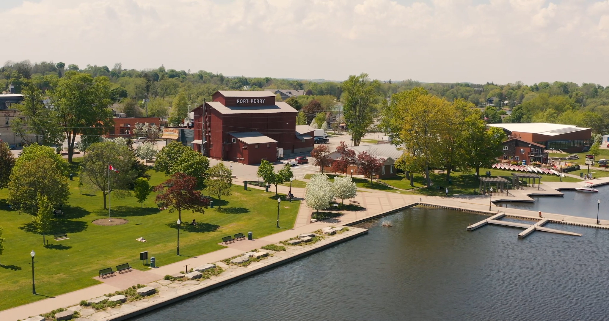 Aerial photo of Lake Scugog, Palmer Park, the Old Mill located in Historic Downtown Port Perry A large aerial shot of Lake Scugog in Downtown Perry. Palmer Park is a large greenspace along the waterfront featuring picnic areas, playgrounds and benches. The marina and Old Mill can be seen in the background. Streets connect to the Historic downtown of Port Perry.