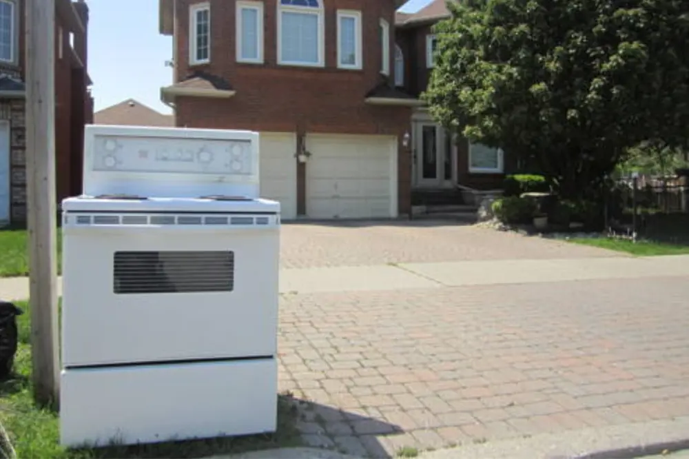 White stove at a residential curbside