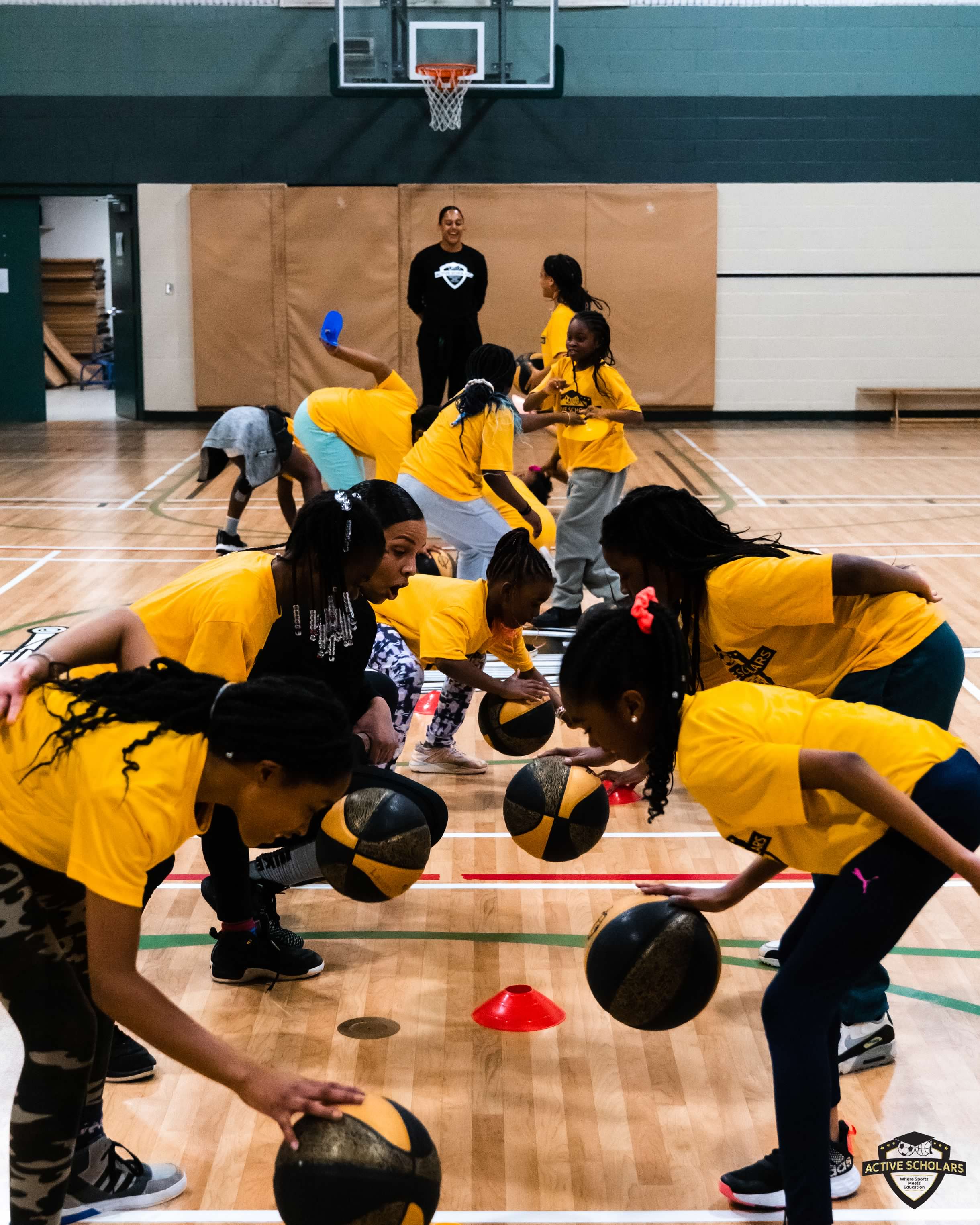 Kids playing basketball in a gymnasium 