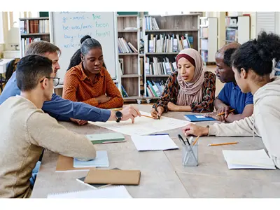Group of people looking at papers on a table