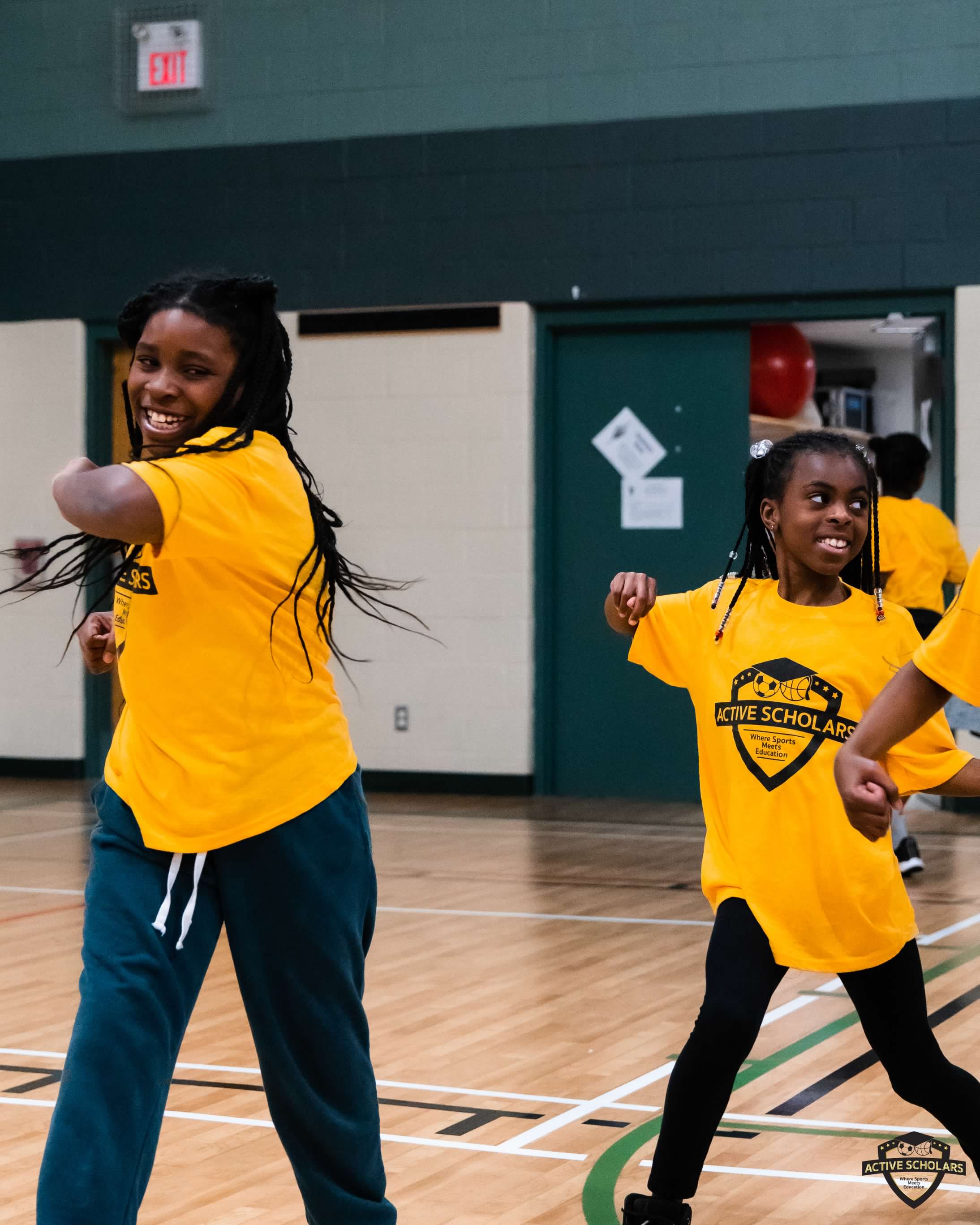 Two girls dancing in a gymnasium