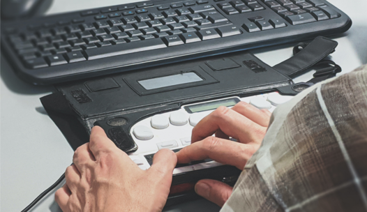 Person using a computer with an assistive device
