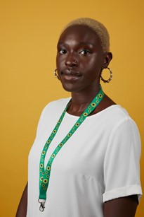 A person with a green sunflower lanyard
