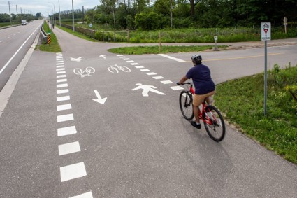 Man cycling through a mixed crossride at an unsignalized crossing.