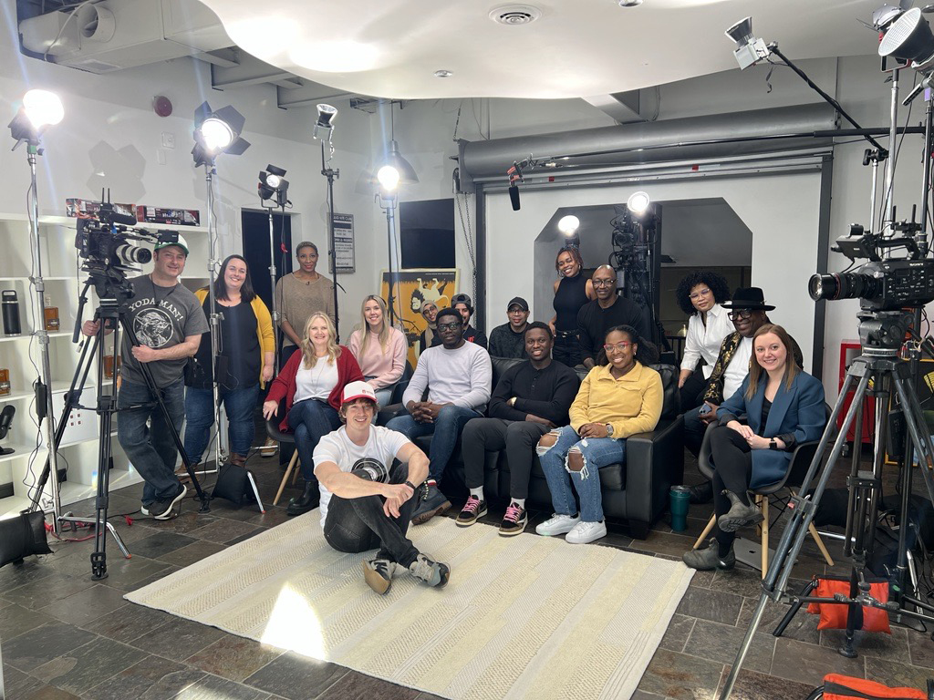 Group of people smiling in a production studio at geekspeak Commerce in Whitby, Ontario
