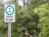 Traffic signage indicating the path is shared by pedestrians and cyclists.